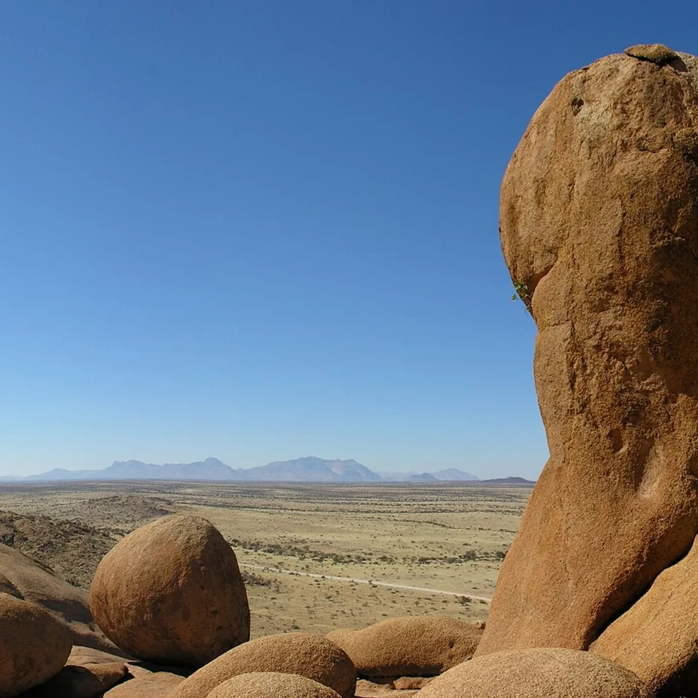 Balanced granite boulder of the Spitzkoppe above the desert floor